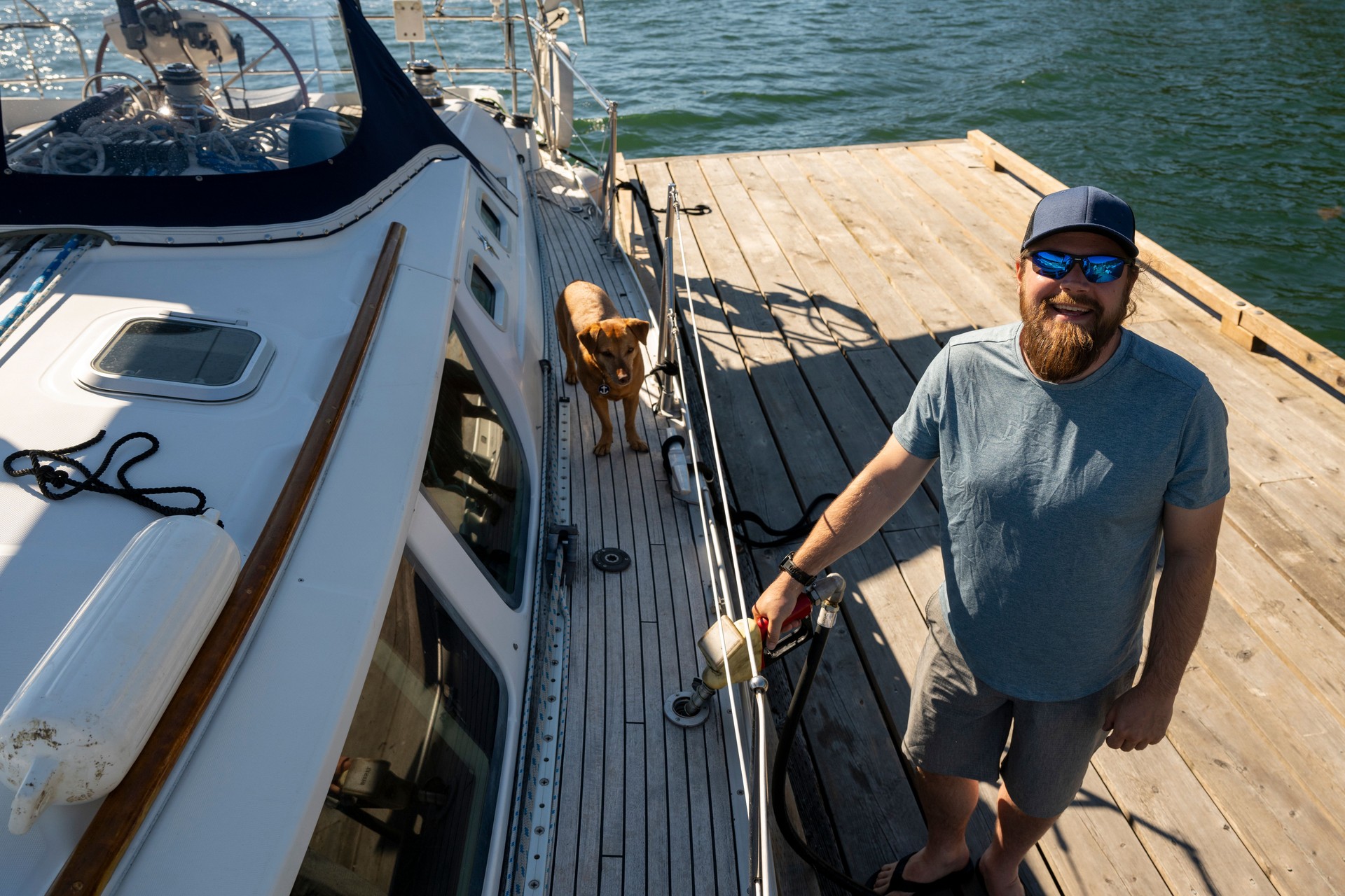 Portrait of captain and dog with sailboat